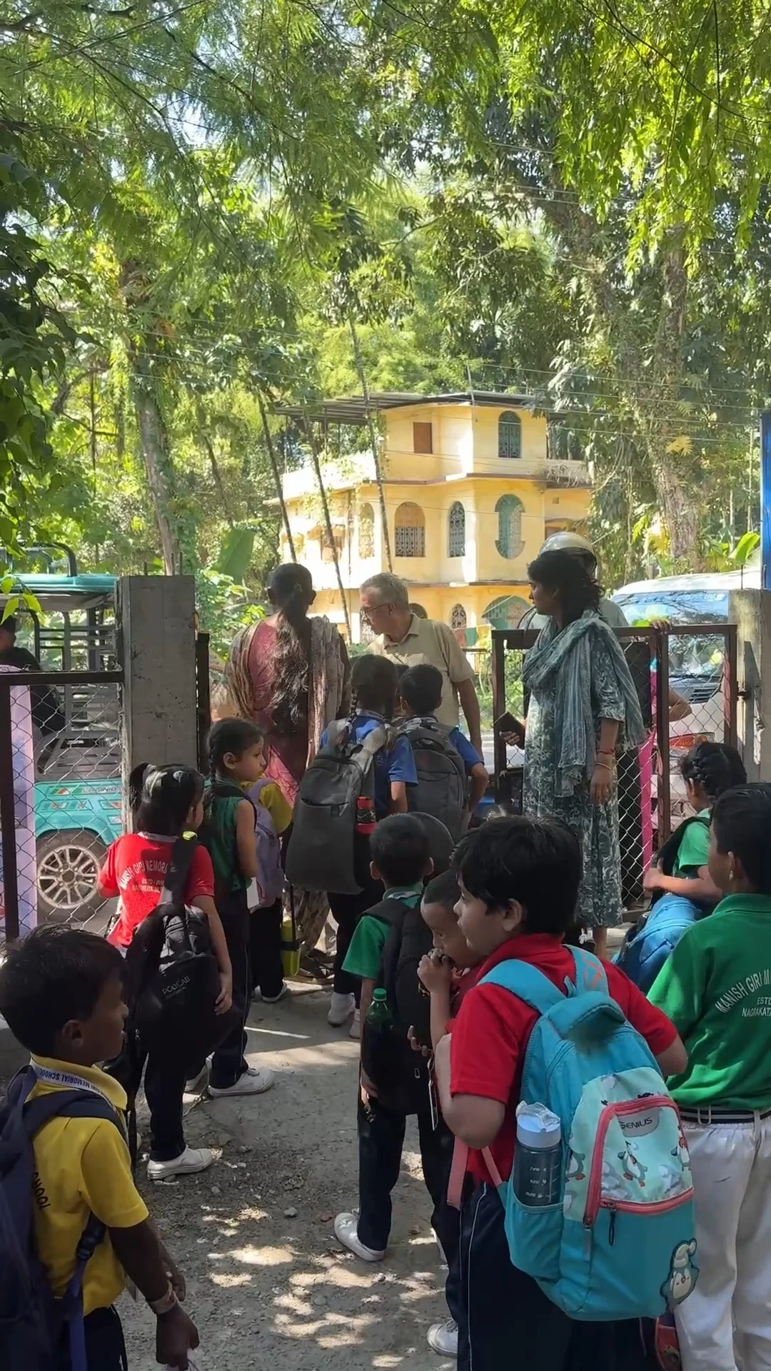 Students with backpacks lined up at the school entrance