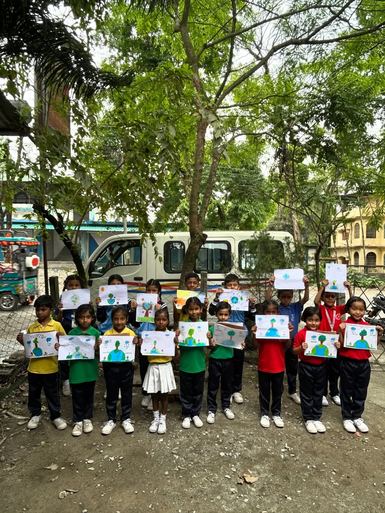 MGM pupils outdoors displaying their drawings about nature