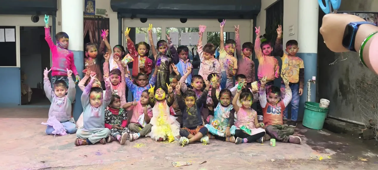 MGM School children covered with festival colours in a school celebration