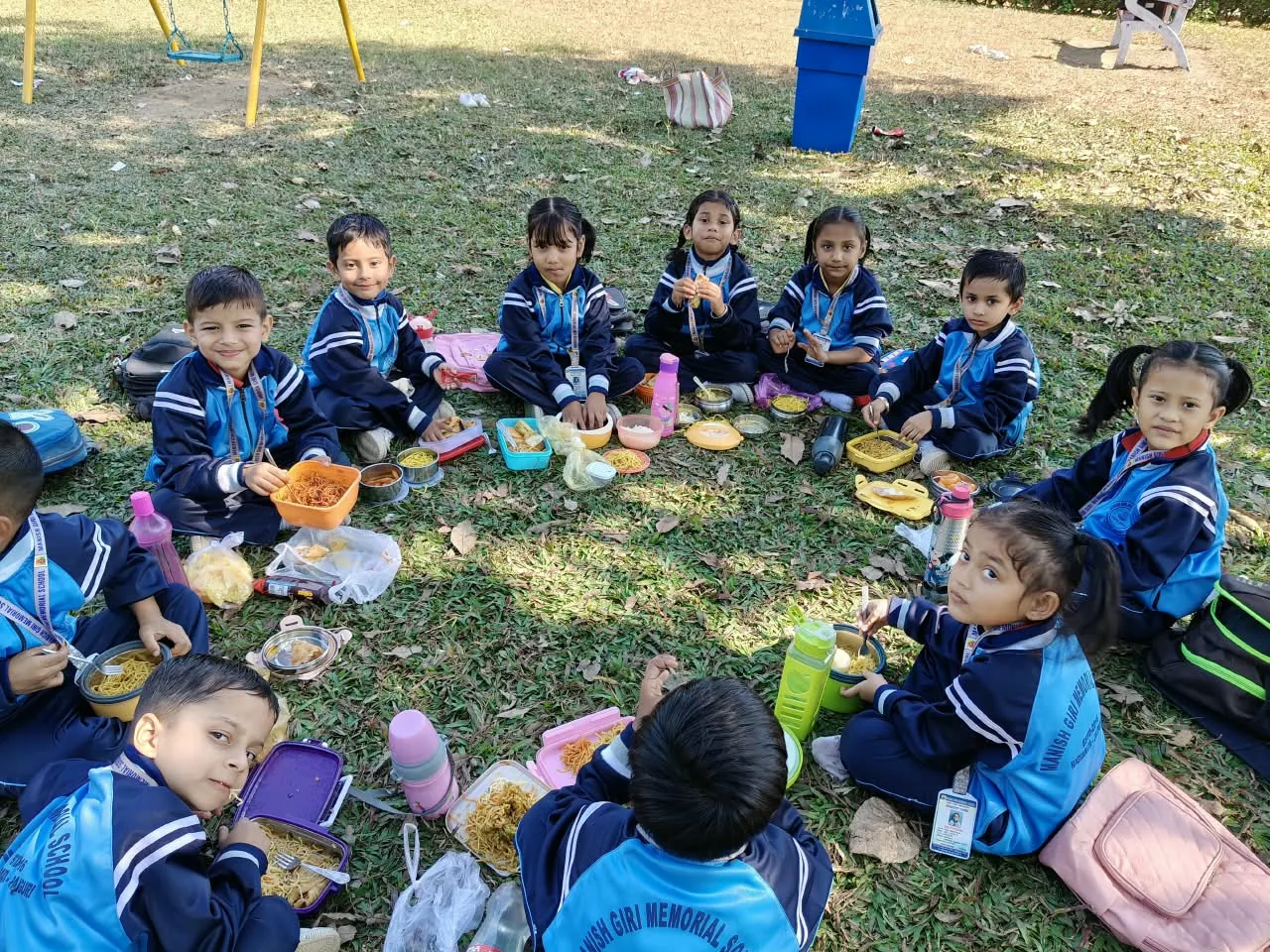 MGM School children sharing lunch outdoors