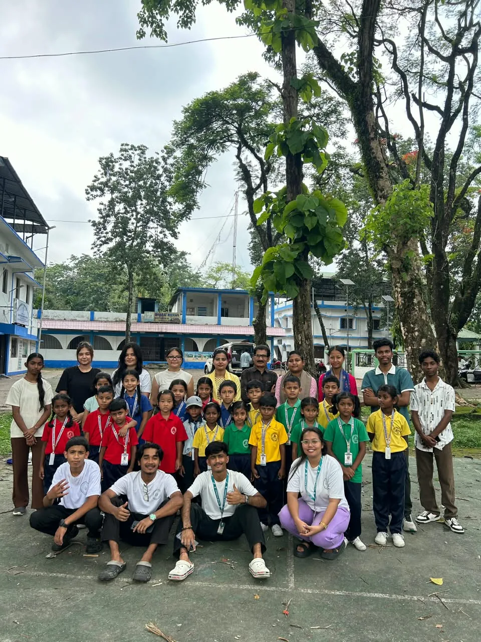 MGM pupils and community volunteers standing together outdoors